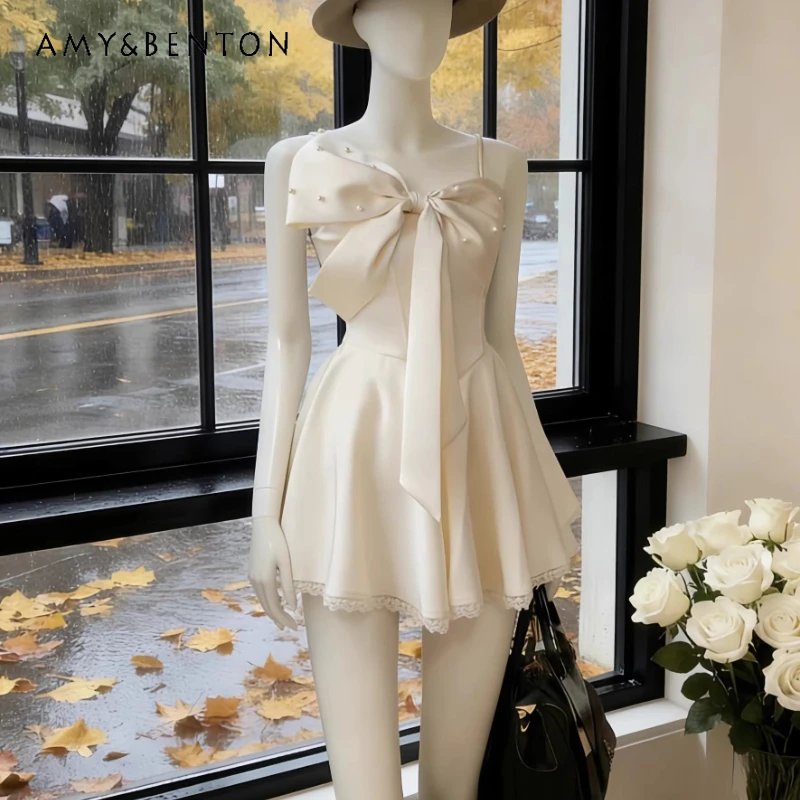 

French Design Beige Bow Women's Sling Dress 2026 Spring Summer New Pearl Decorative Lace Splicing Sweet Short Dresses Ladies