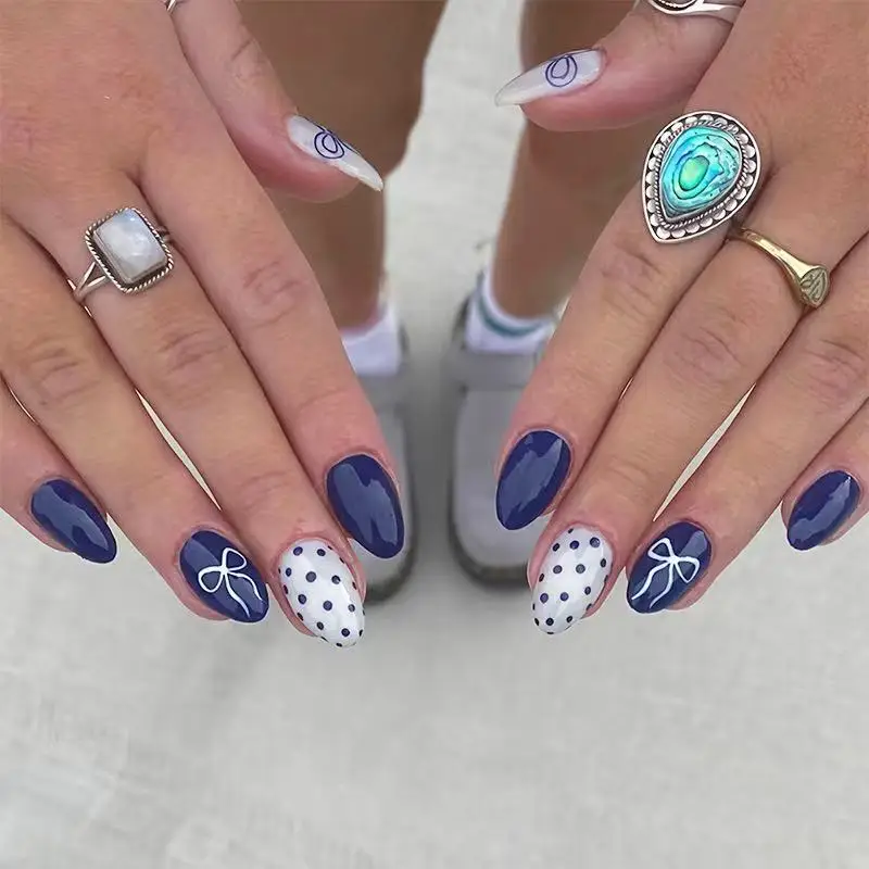 24PCS Navy blue and white polka dot oval artificial nails featuring hand-painted bow patterns Simple and fashionable manicure