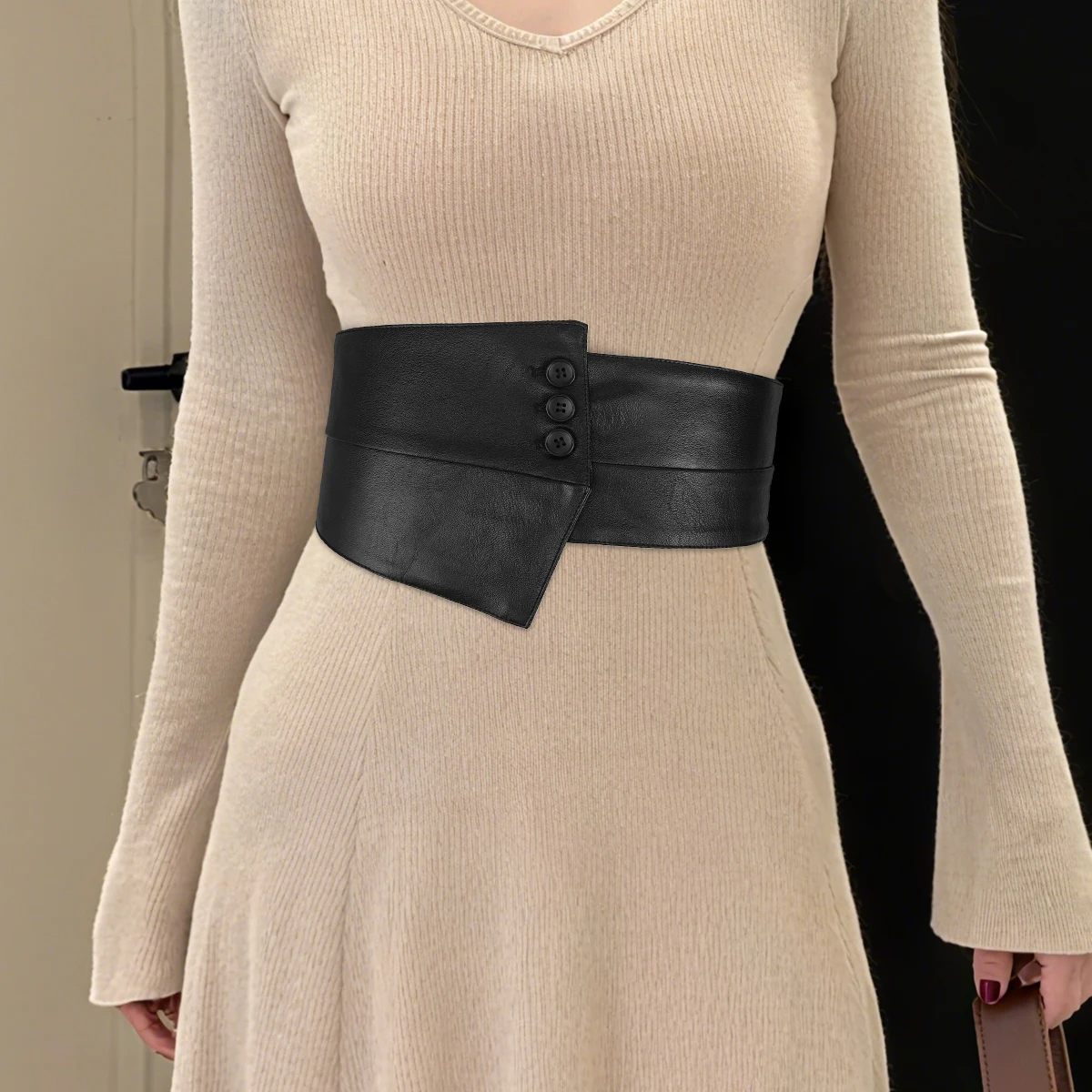 A black wide-belted women's fashion dress decorated with an irregular design of PU leather waistband and elastic corset
