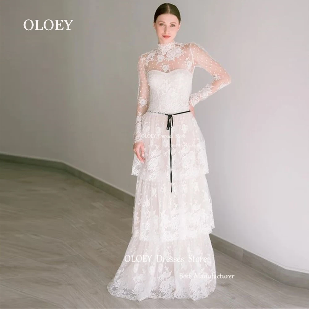 

OLOEY Luxury White Tiered Lace Wedding Dress Long Sleeves High Neck Bridal Gown Floor Length Zipper Back Straight Black Sashes