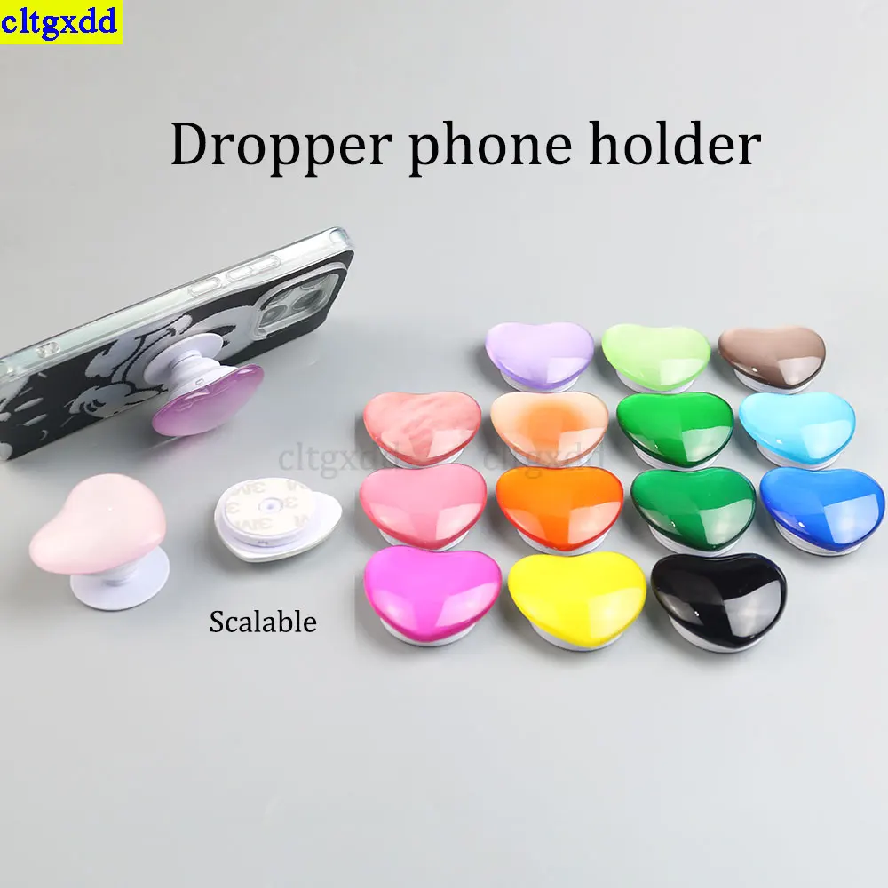 Cltgxdd, 1 pieza, pegamento transparente en forma de gota, soporte para teléfono 3D brillante en forma de corazón, soporte para airbag, agarre universal para teléfono plegable estirable