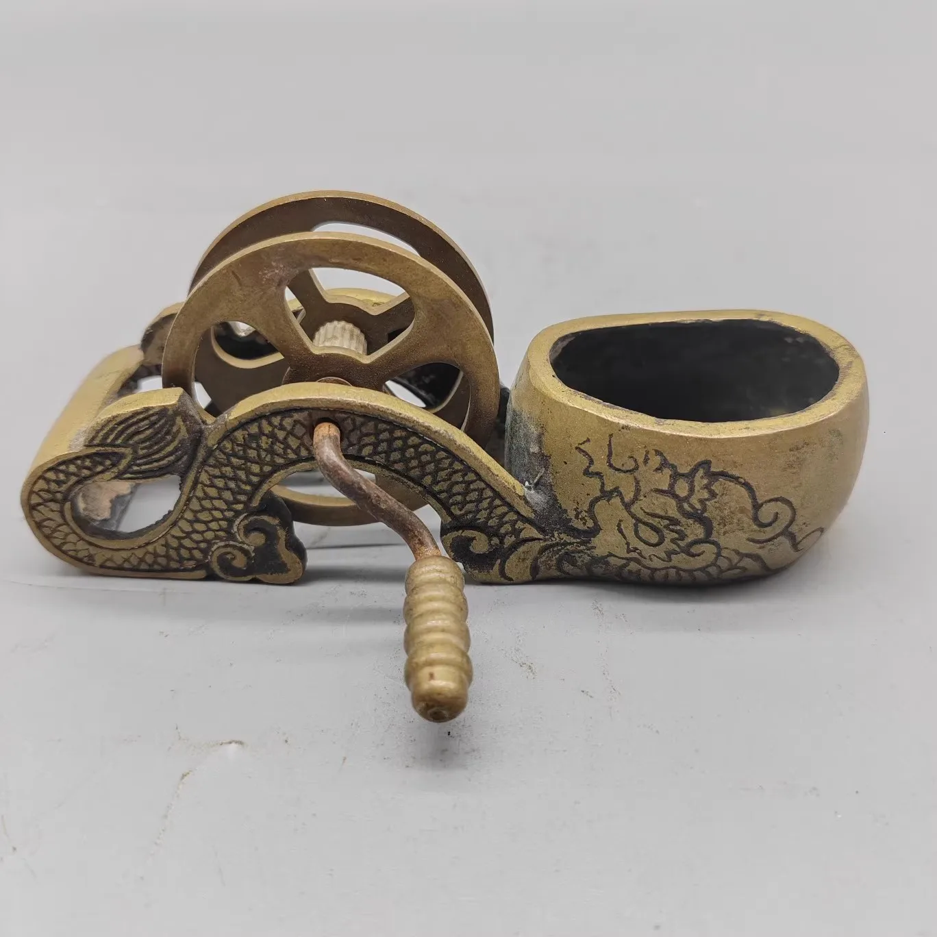 Antique ink line box with traditional copper dragon design, used for carpentry tools