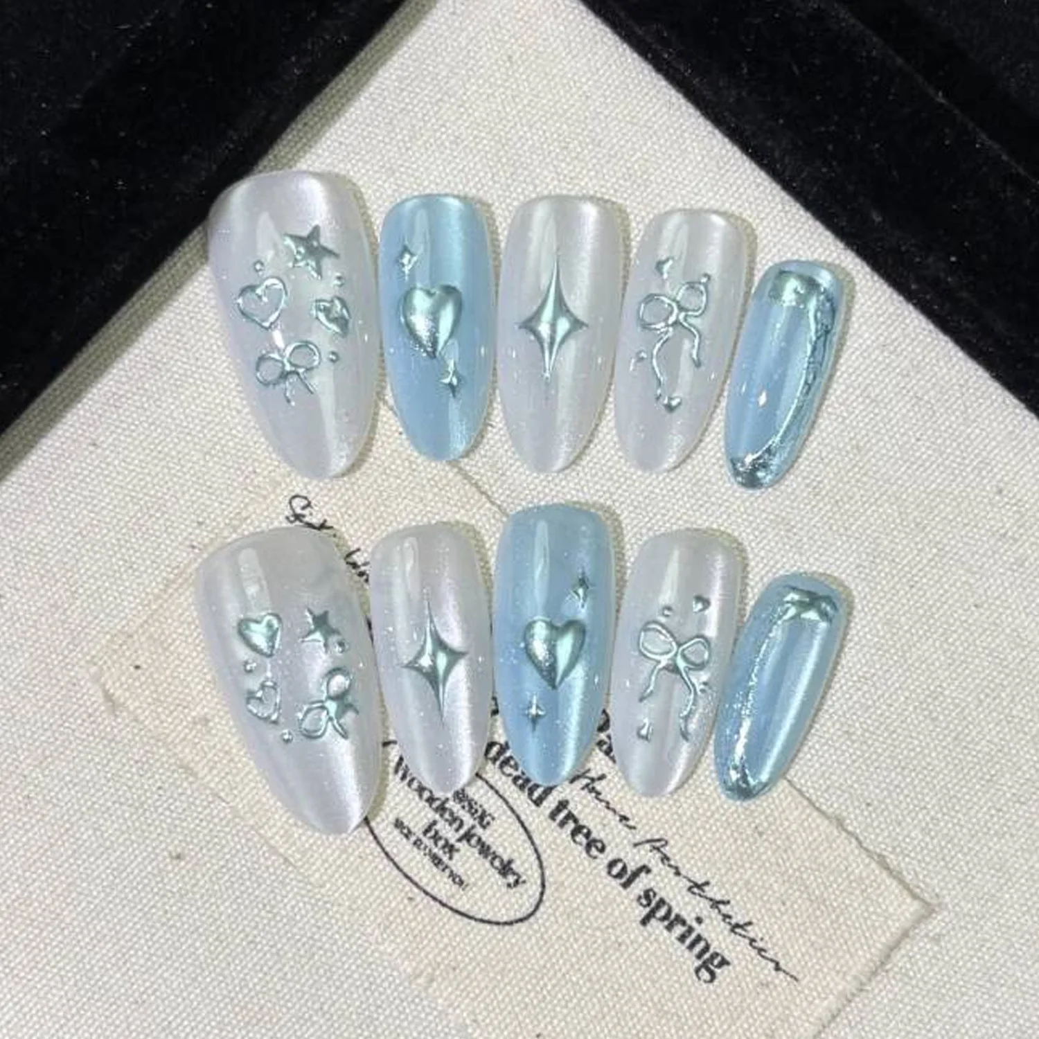 

24PCS Almond False Nails Y2K Spice Press on Nails Metallic Silver Flame and Star Designs French Tip Glue on Fake Nails for Women