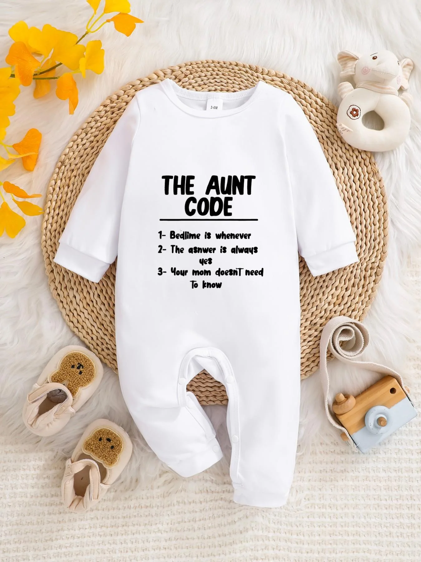 A baby long-sleeved onesie with interesting letter prints. It features a buttoned design for easy putting on and taking off, and