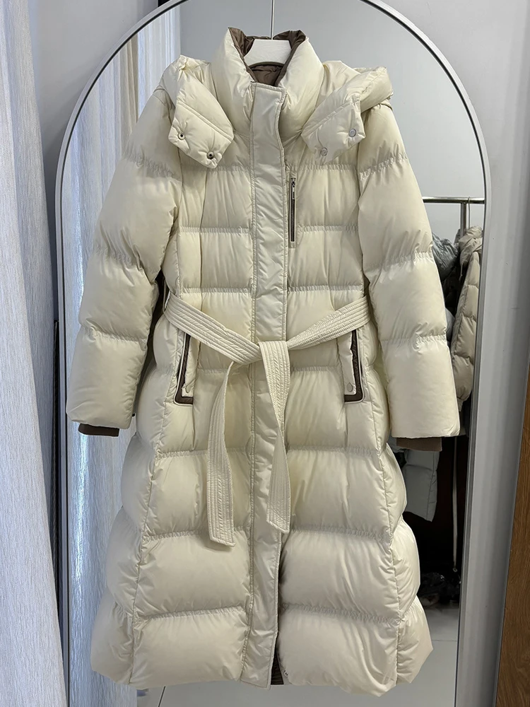 Elegant Long down jacket with hooded women's 2026 Winter High quality warm puffer coat with sashes Female outwear INKEO DJ640