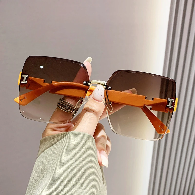 

New style frameless two-color gradient high-end sense women's trendy driving sunglasses fashionable sunglasses.