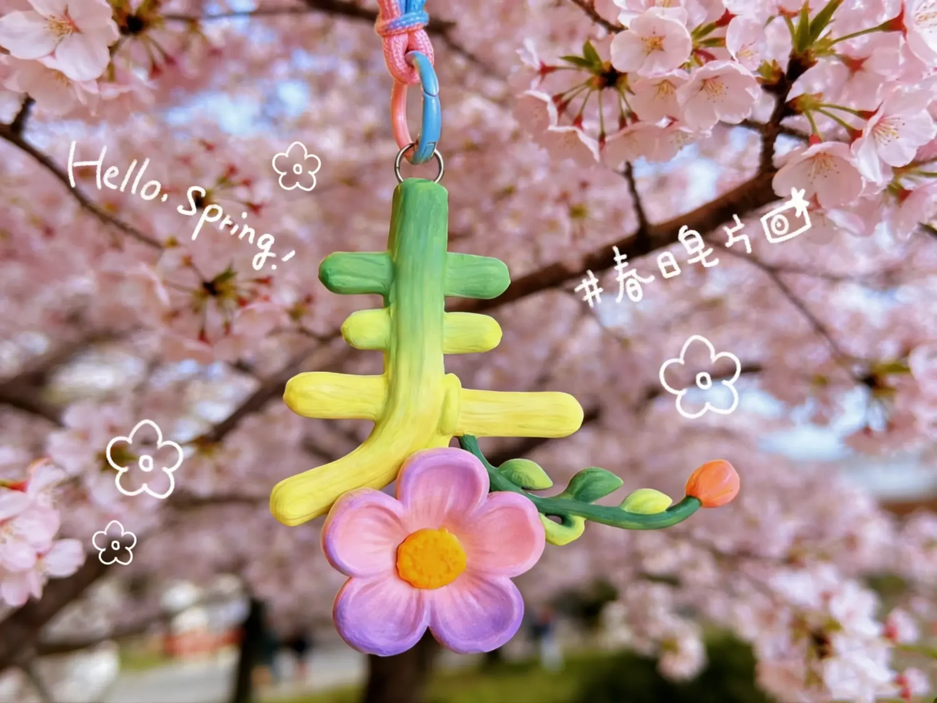 

Spring charms, blending text with spring blossoms, bring a touch of springtime vibrancy when hung on a bag.