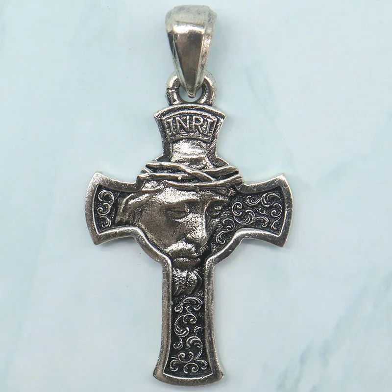 Buy 3 Get 1 Free This Catholic prayer cross pendant features a delicate depiction of Jesus' face, crafted to inspire devotion