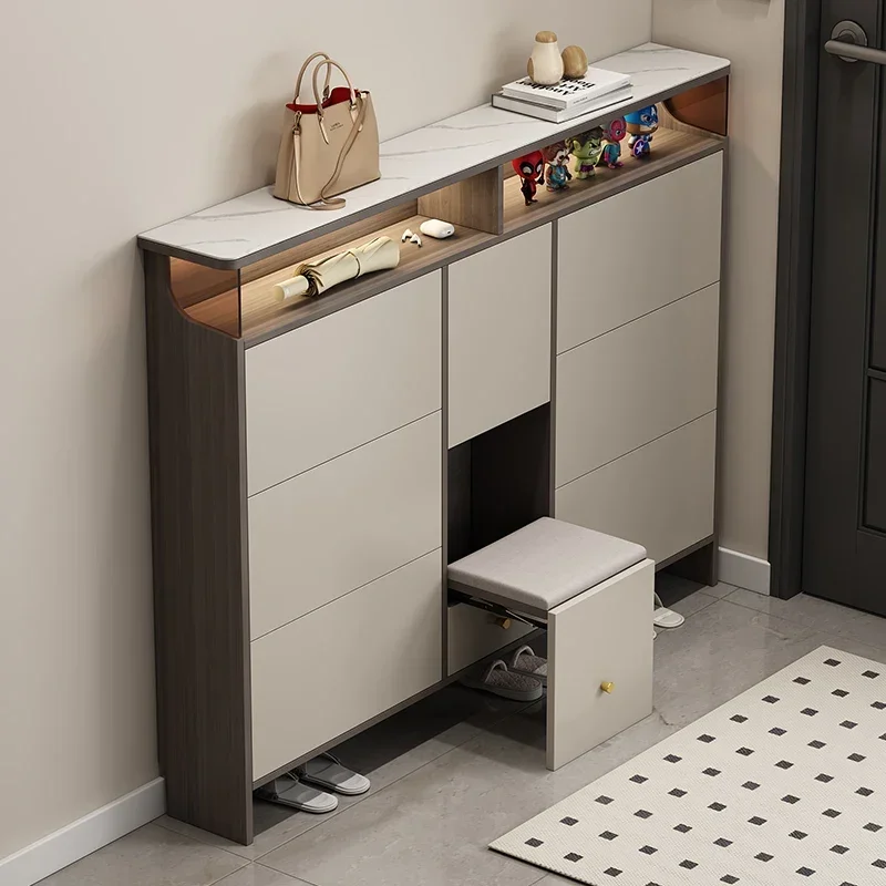 Ultra-thin tipping bucket shoe cabinet, modern interior, integrated shoe rack with stool against the wall and entrance