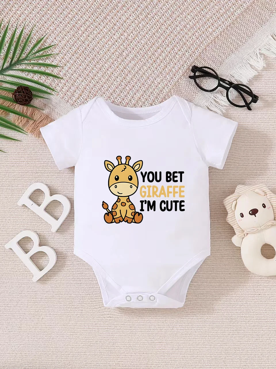 Playful letter-printed baby short-sleeve triangle bodysuit. Button closure for easy dressing, machine washable