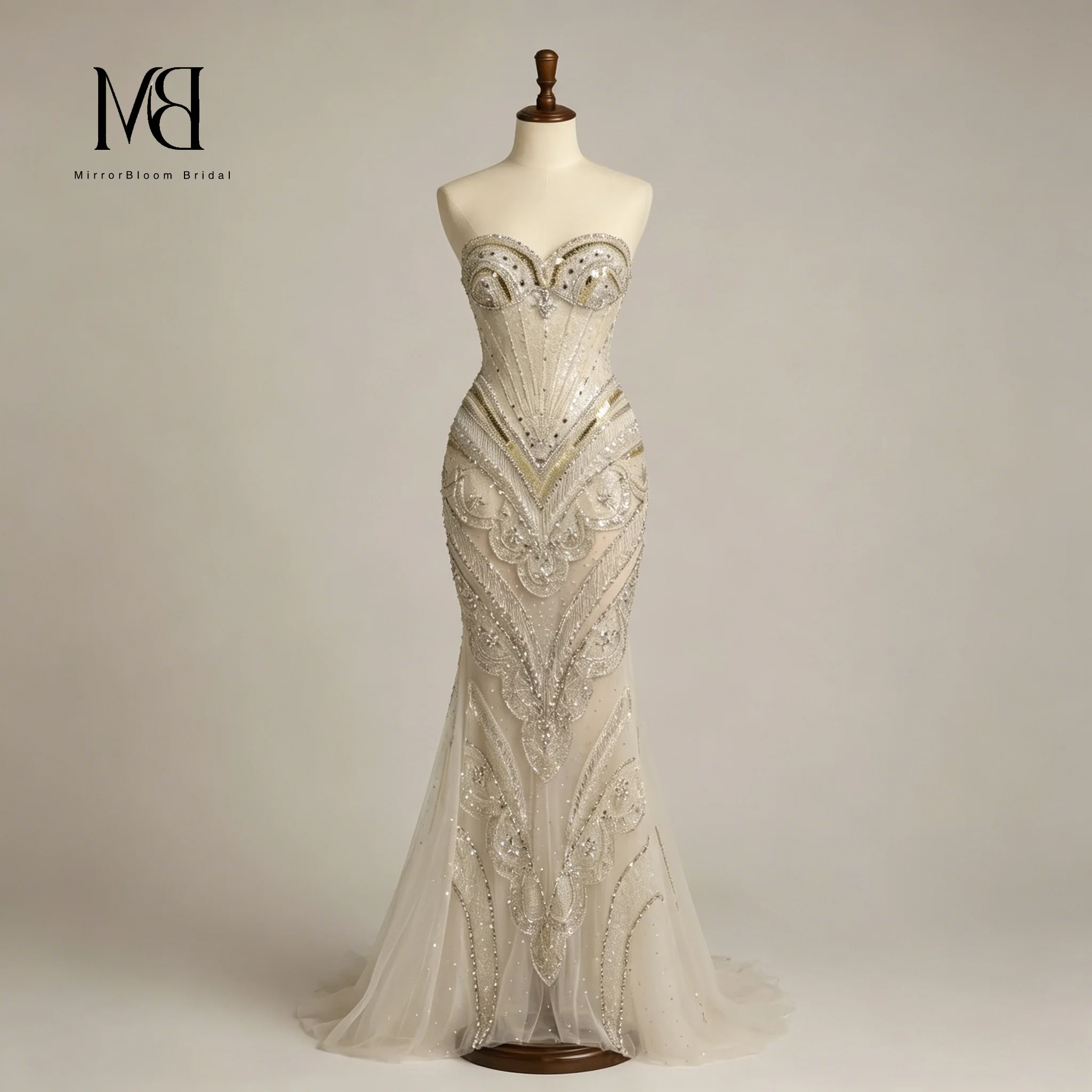 Stunning ivory strapless sleeveless floor-length mermaid formal gown featuring beaded tulle detailing