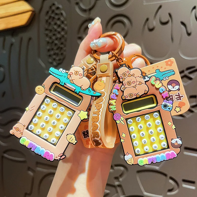 2025 nuevo llavero de calculadora Capibala lindo llavero de capibara de dibujos animados estudiante mochila colgante temporada escolar pequeño regalo