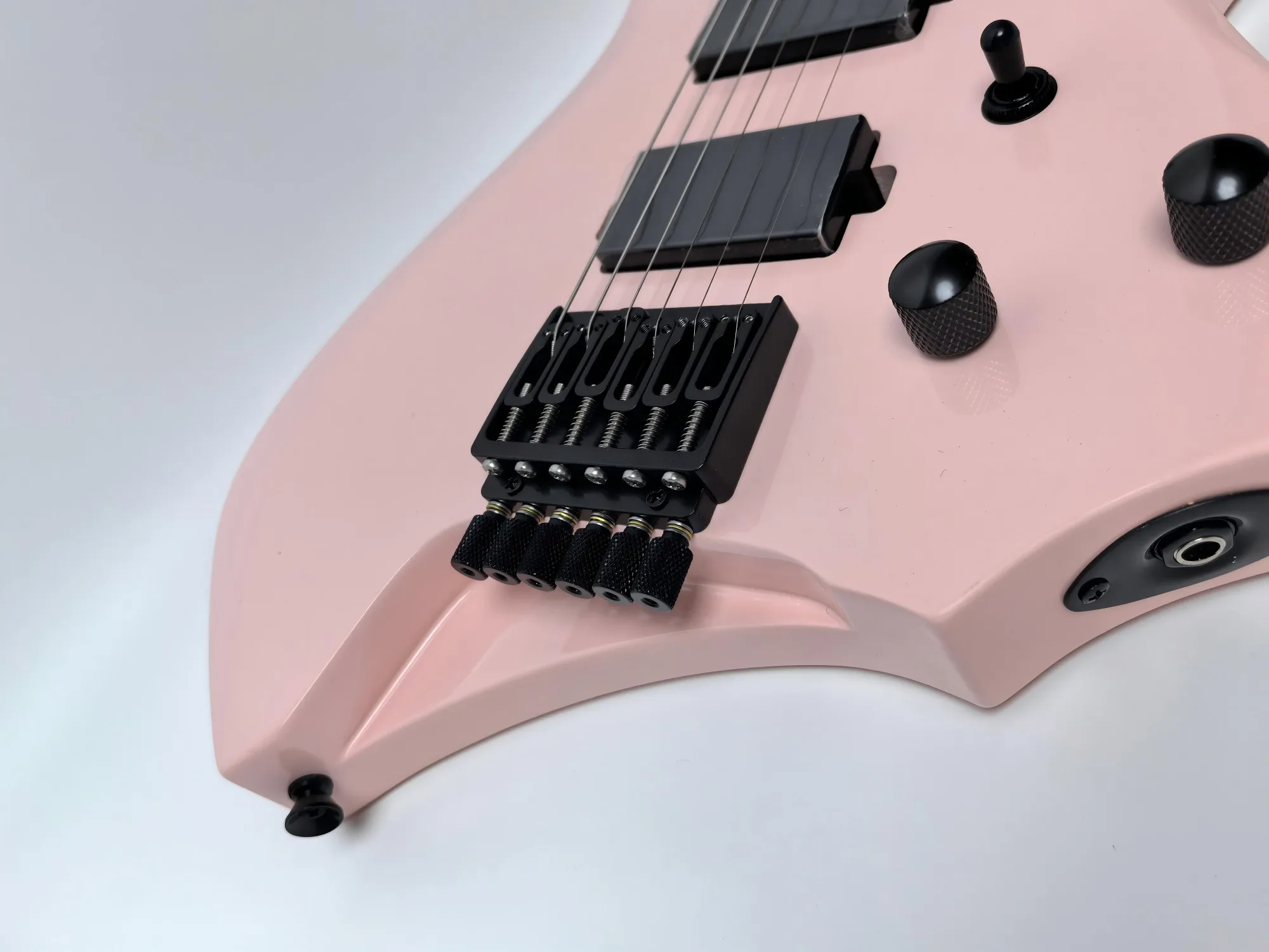 In stock. Can be shipped when placed. High quality pink headless 6 string electric guitar. Factory direct. Can be customized.