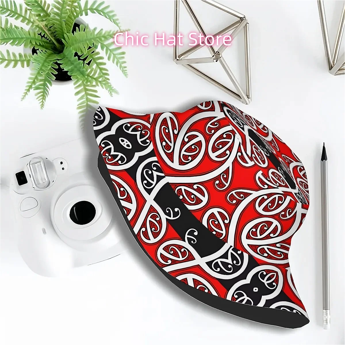 A Unisex Bucket Hat Featuring Vibrant Red And Black Geometric Designs Inspired by Maori Culture, Perfect for Outdoor Activities
