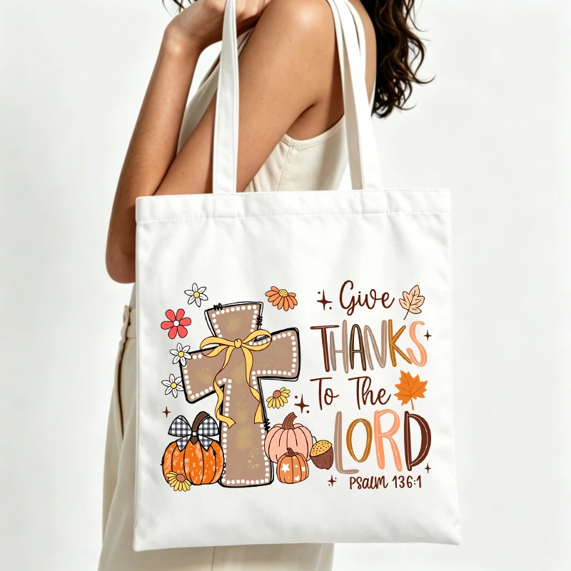 cross and pumpkin graphic canvas tote bag with autumn floral design, ideal for casual fall outings and daily use