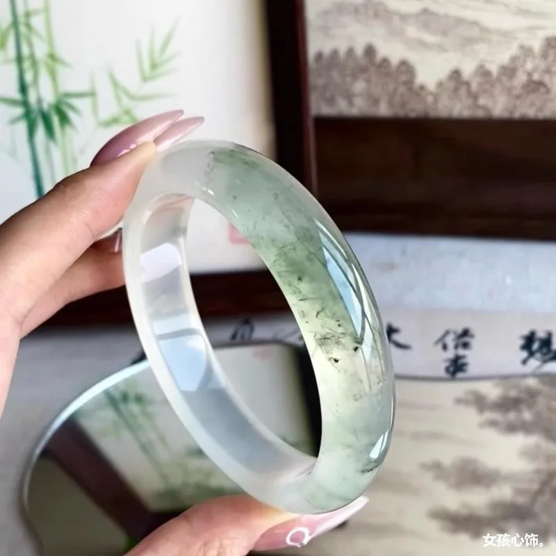 Natural Burmese ice-type jade bracelet with floating floral patterns, featuring a clear, glass-like jadeite stone, a stylish bra