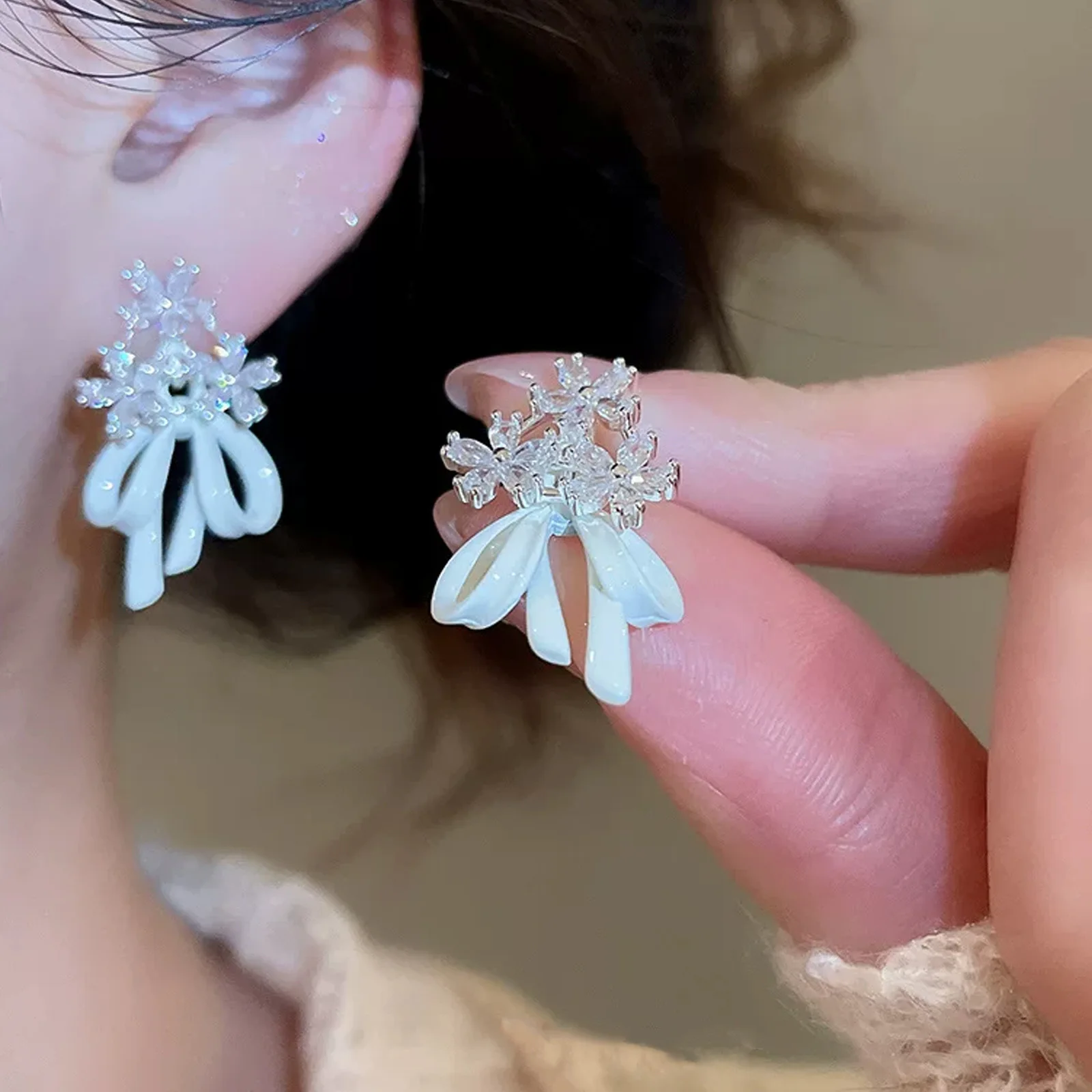 

Ladies' Style: 2026 New Trendy and Uncommon Design French Zircon Hand Chain Earrings. High-end summer earrings, suitable for daily wear, travel or parties.