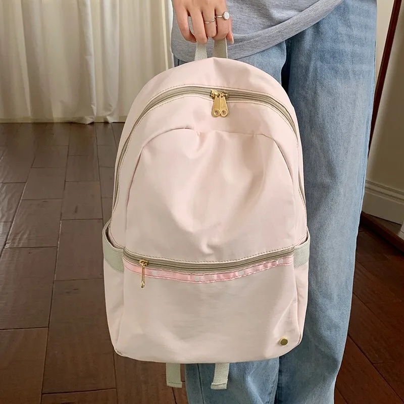 

Korean 2025 new light pink backpack for women with large capacity, versatile commuting, simple student backpack, travel backpack
