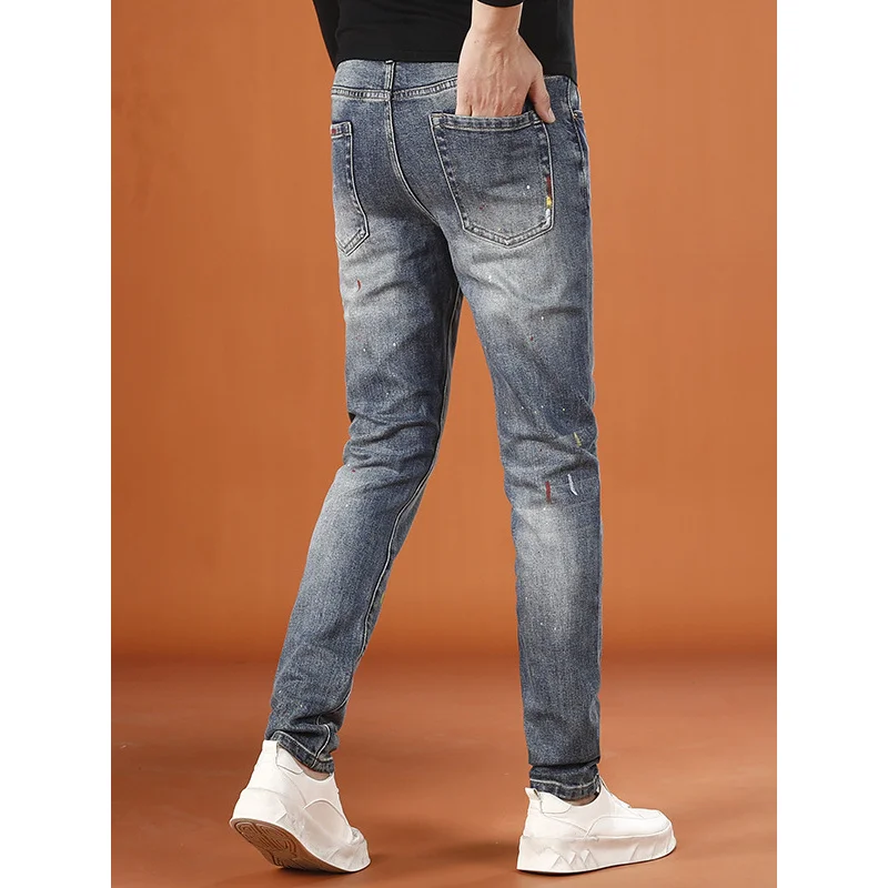 2025 autumn new trend fashionable splashed ink printed men's jeans autumn and winter elastic small leg pants