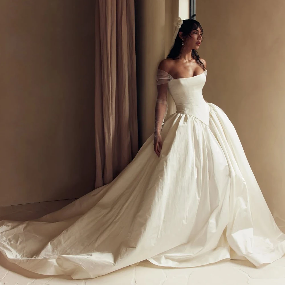 

Customized Satin Bridal Dress With Detachable Sheer Gloves Voluminous Ball Gown And Elegant Train For Indoor Bridal Shoot