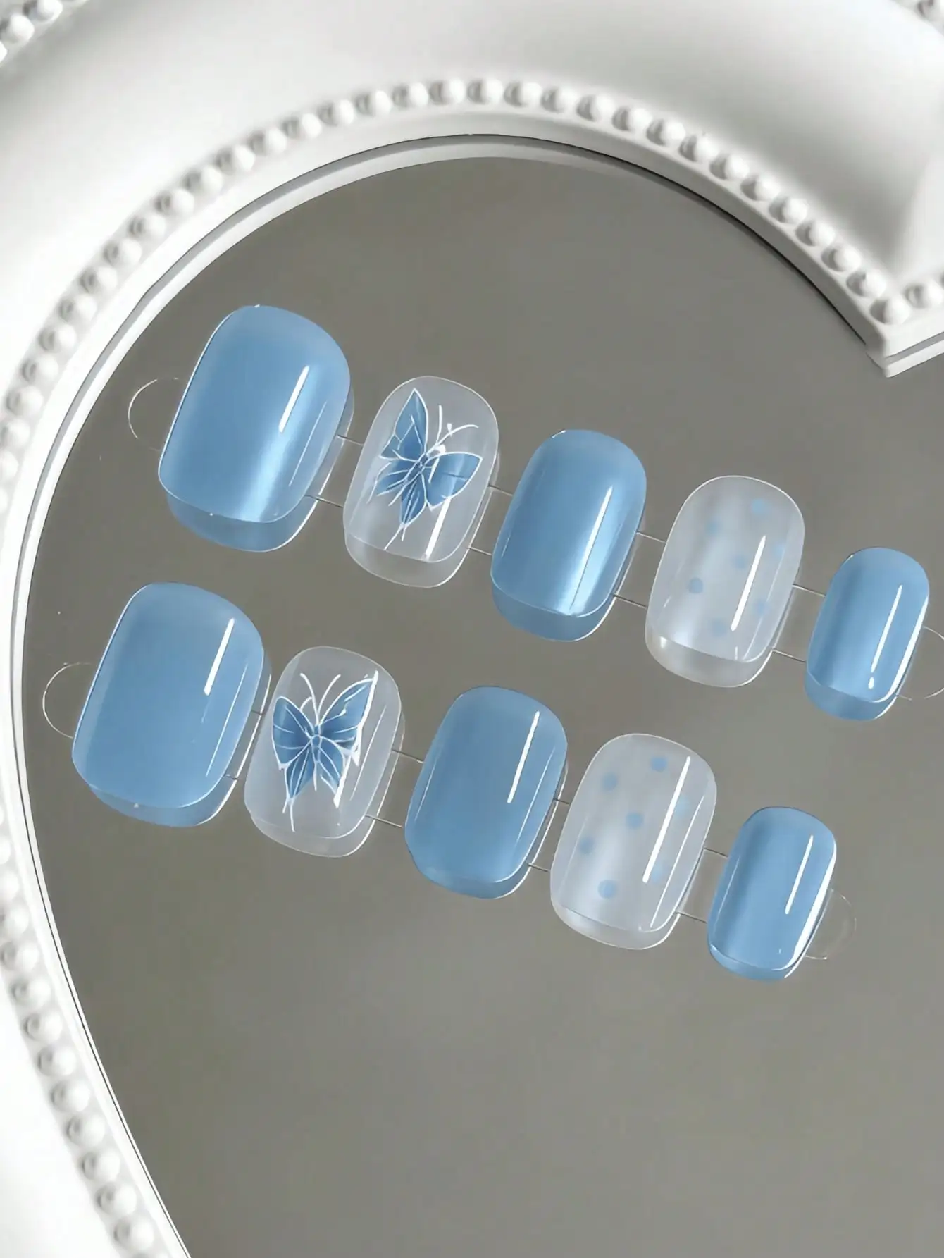 10 Pieces of Short, Light Blue Butterfly Polka Dot Press-On Nails, with a Clear and Gentle Style, Featuring Hand-Painted Butterflies, Polka Dots, and Cat Eye Blue Designs, Using Nude Color Contrast and Hand-Painted Techniques, Suitable for Young Girls and Young Women, Perfect for Daily Commuting, Fresh Dates, and Campus Settings, Comes with Jelly Glue and Nail File