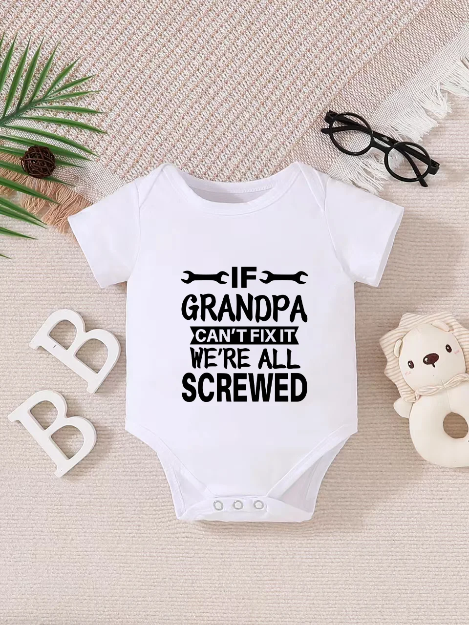 Playful letter-printed baby short-sleeve triangle bodysuit. Button closure for easy dressing, machine washable