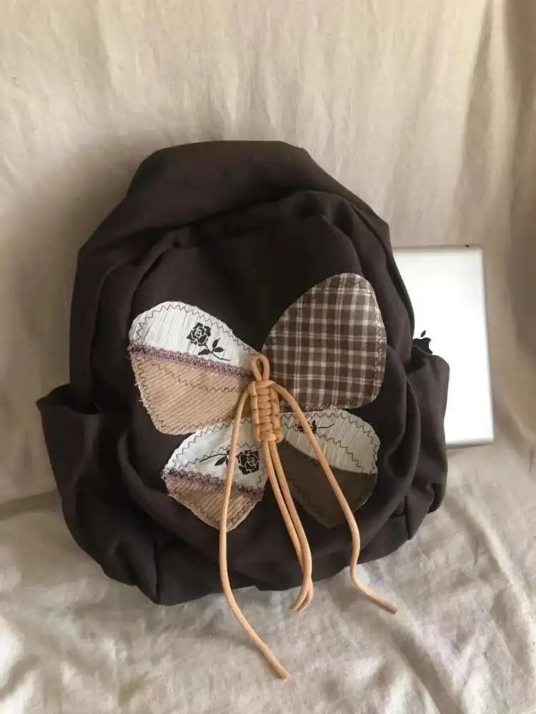 2025 ใหม่ Patchwork ผีเสื้อกระเป๋านักเรียนกระเป๋าเป้สะพายหลังไหล่กระเป๋านักเรียนวัยรุ่นของขวัญ B1979 hit