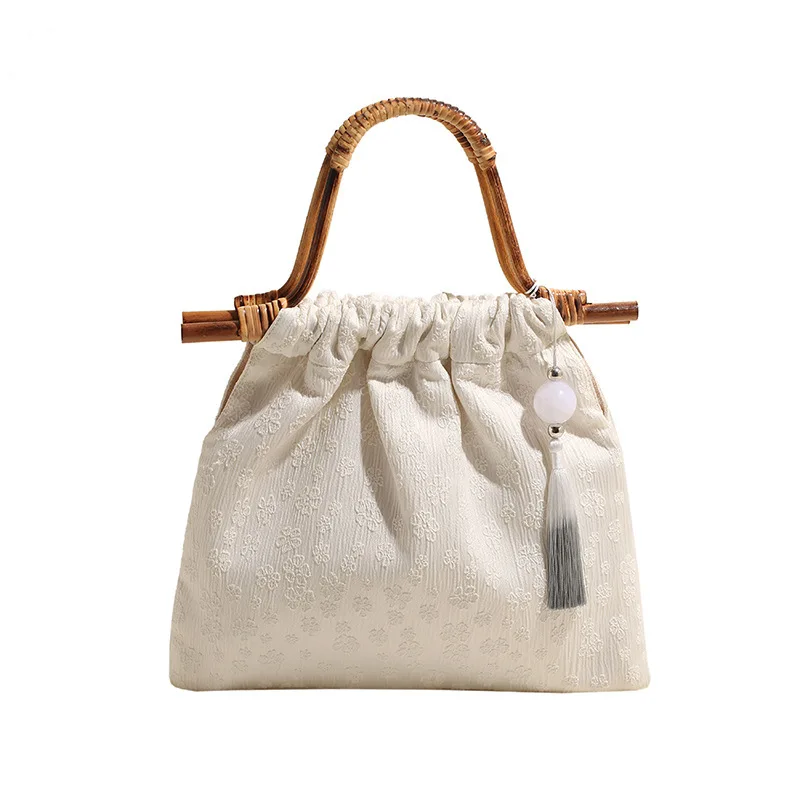 

New Chinese style handbag for women with a sense of niche design. Commuter women's bag with a new clip on pearl tassel handbag