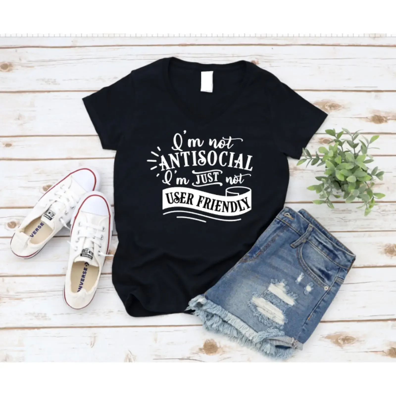Black t shirt with humorous text design on a wooden surface shoes and shorts www missmafia com vintage Washed Slightly fashion