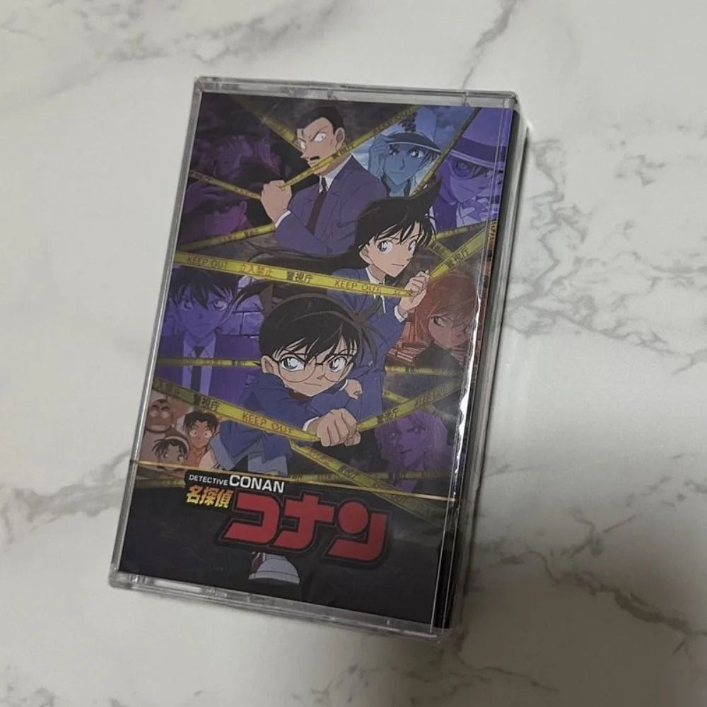 

Совершенно новая запечатанная кассета: классическая аниме-коллекция саундтреков, лучшие песни из «Детектива Конана» с буклетом с текстами песен