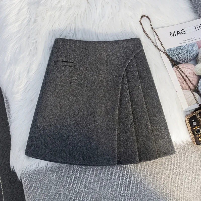 French high-grade gray woolen A-word skirt in autumn and winter, the new high-pocket hip irregular pleated skirt short skirt.