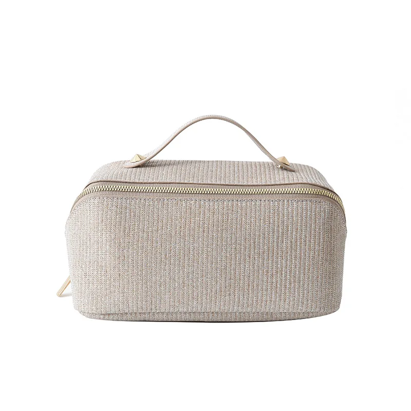 New Portable Makeup Bag with Large Capacity Zipper Partition and Multi functional Texture PU Handheld Toilet Bag for Women