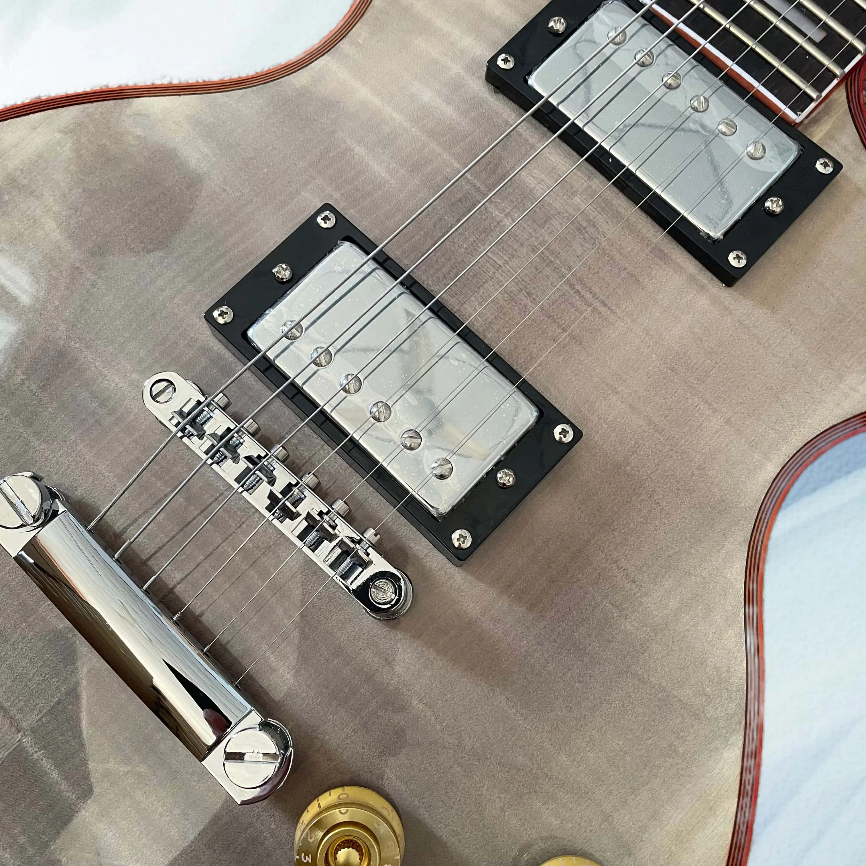 Transparent black electric guitar with red binding, chrome hardware, and a rosewood fingerboard view 2
