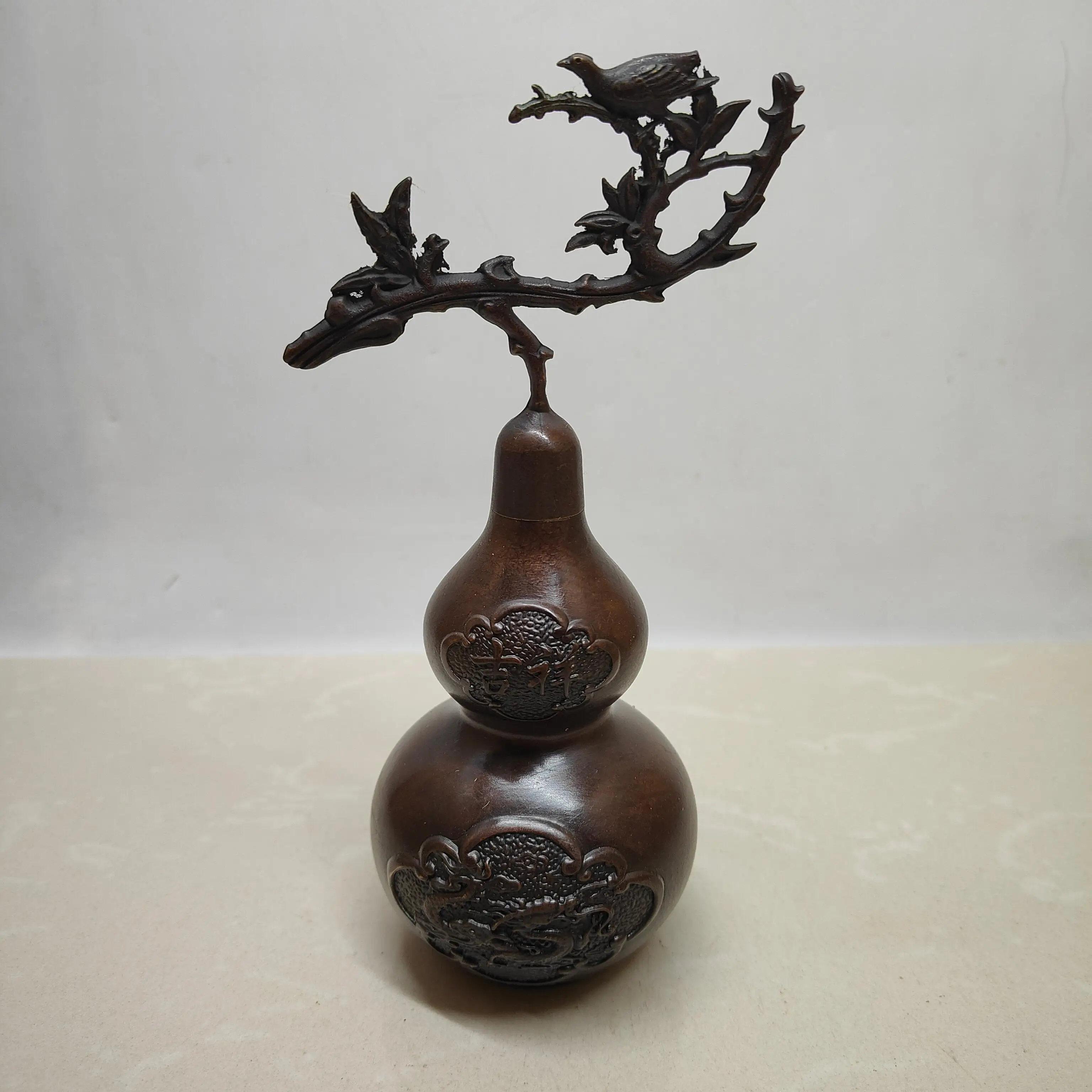 A lucky and prosperous gourd made of brass, finished to resemble antique bronze