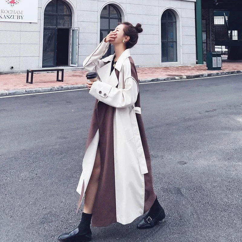 

A new mid-length women's windbreaker with cinched waist and stylish knee-length coat