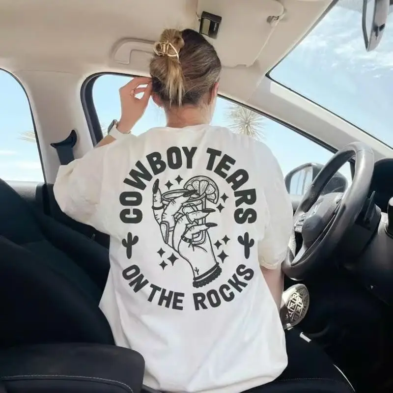 

Trendy T - Shirt Featuring "Cowboy Tears on the Rocks" Graphic, Ideal for Fashion - Forward Looks