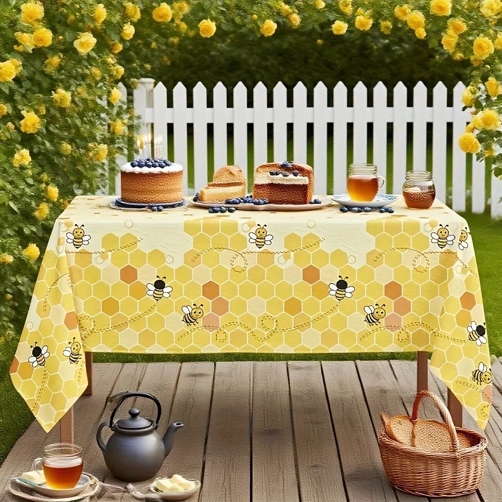 Bees-themed party tablecloth, with a yellow honeycomb pattern design.