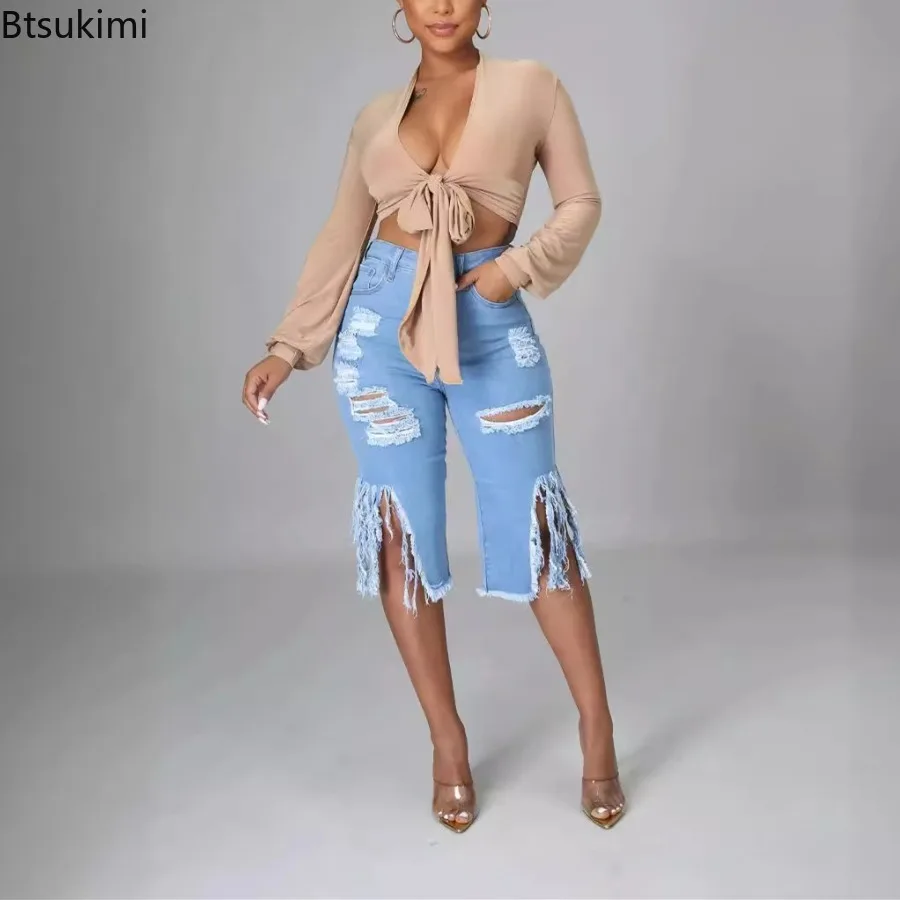 女性の夏の膝丈ジーンズデニムウォッシュタッセルリッピングハイウエスト穴パンツ女性のためのスプライスストリートスキニーパンツ