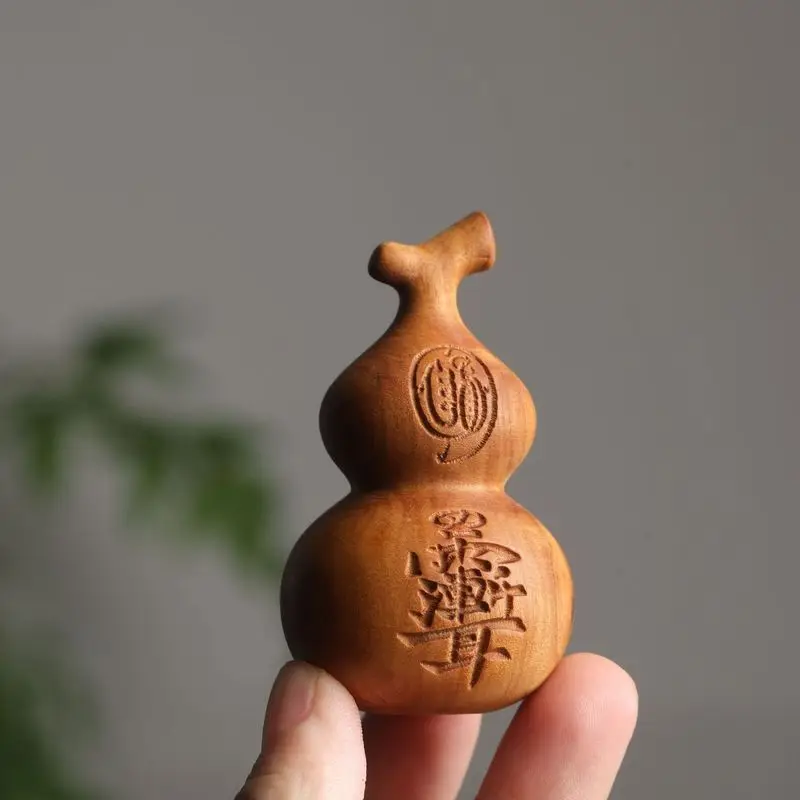 Lightning-struck jujube wood, purple cypress, and gourd are intricately carved into a three-dimensional pendant. It's a wooden a