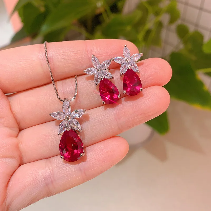 

Elegant Pear Shaped Teardrop Red Gemstone Necklace and Earrings Set Sparkling Accents Perfect for Weddings Parties and Gifts