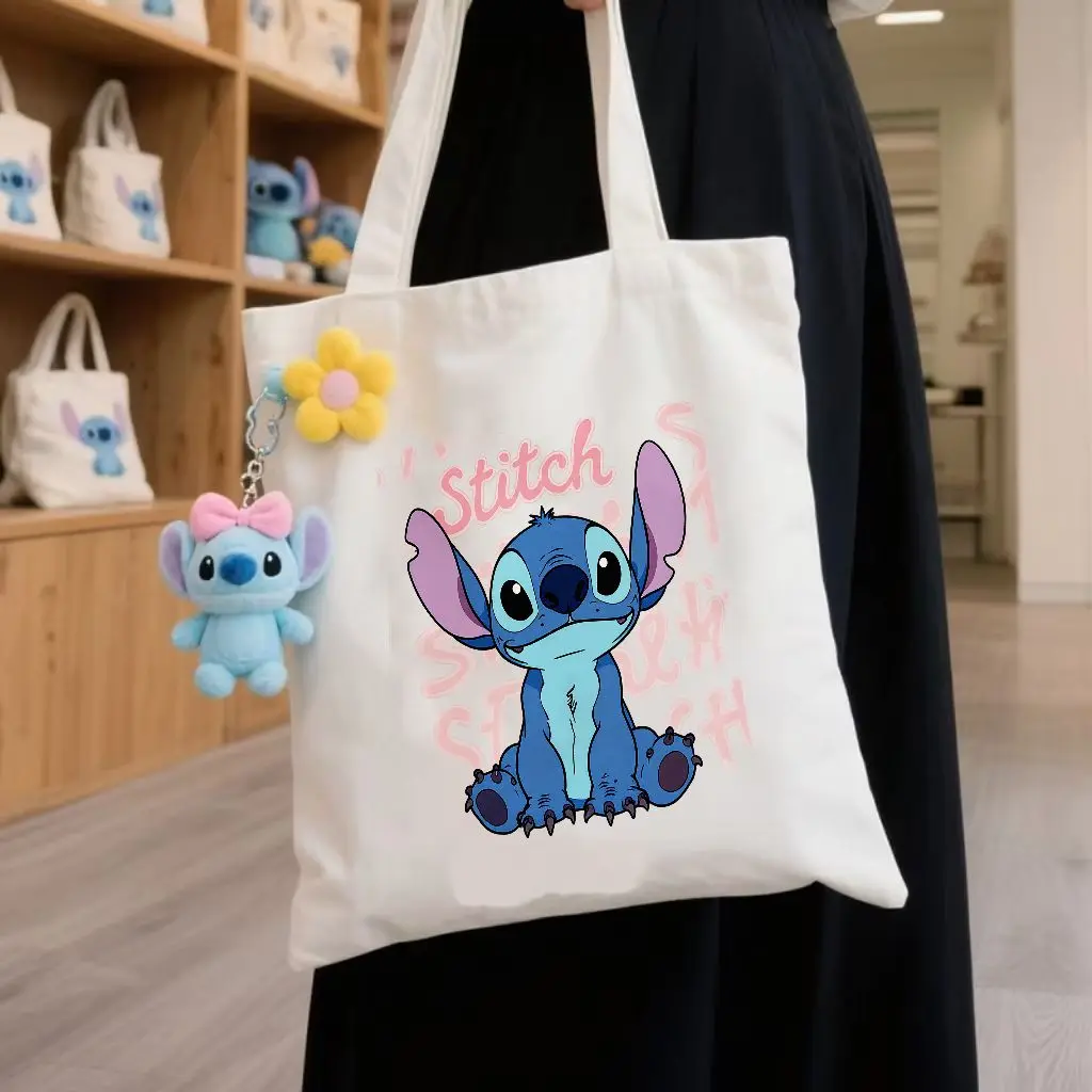 حقائب اليد المصنوعة من القماش باللونين البيج والأسود من Lilo & Stitch - رسم توضيحي لشخصية الغرز الملونة، اقتباس تحفيزي 'معرف ماذا أنت #1
