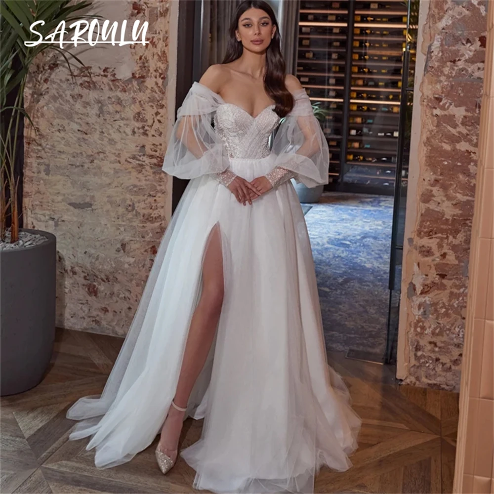 Luxury Shimmering A-line Lace Bridal Gown with Sheer Off-Shoulder Puff Sleeves, Embellished Corset, Romantic Tulle Split Skirt