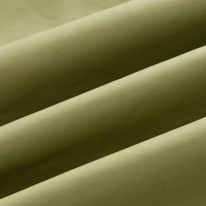 เสื้อโค้ทกันลมหนังยาวสีพื้นทรงหลวมประดับเข็มขัดที่ไหล่  คอลเลคชั่นฤดูใบไม้ร่วงใหม่สำหรับผู้หญิงจาก KEYANKETIAN