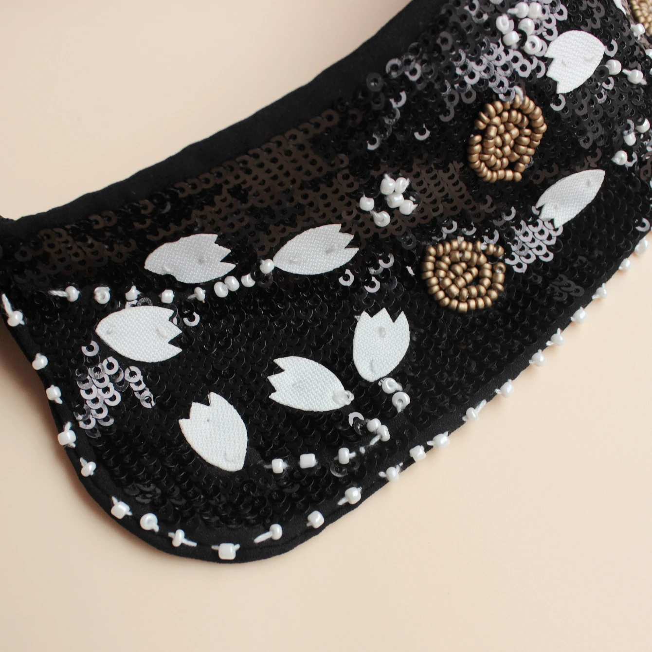 Fashion accessory, luxurious sequined false collar. Classic black background with white flowers. Inlaid with shining bead orname