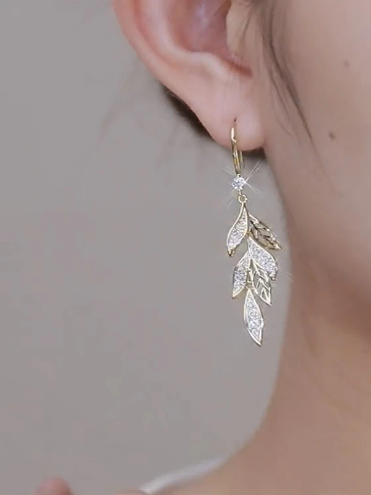 

Golden diamond studded tassel leaf earrings