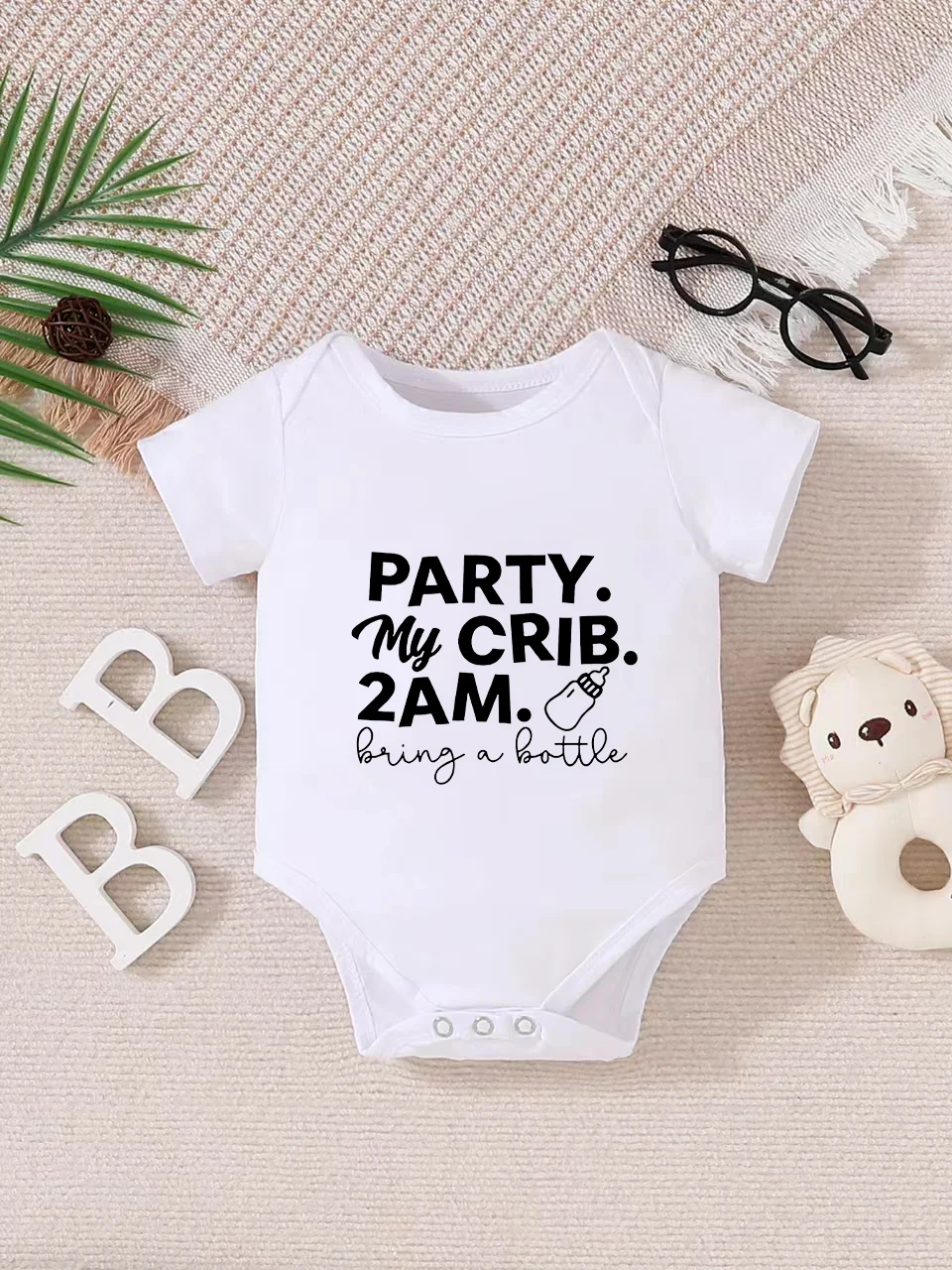 Playful letter-printed baby short-sleeve triangle bodysuit. Button closure for easy dressing, machine washable