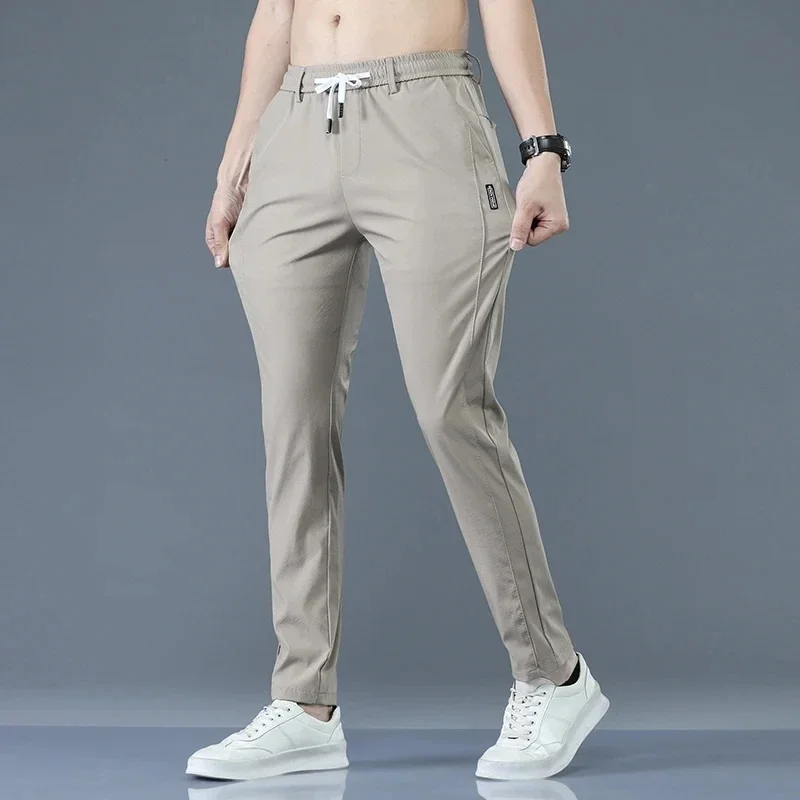 

New Men Quick Dry Elastic Sports Pants Summer Autumn Light Thin Tracksuit Trousers Casual Solid Color Pocket Sweatpants