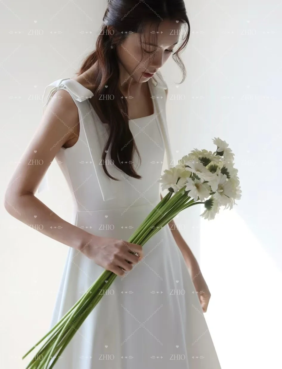 ชุดแต่งงานผ้าซาตินสีขาวเรียบง่าย สายเดี่ยวผูกโบว์ ชุดราตรีสไตล์เกาหลี สำหรับถ่ายภาพ ชุดเจ้าสาวสั่งตัด