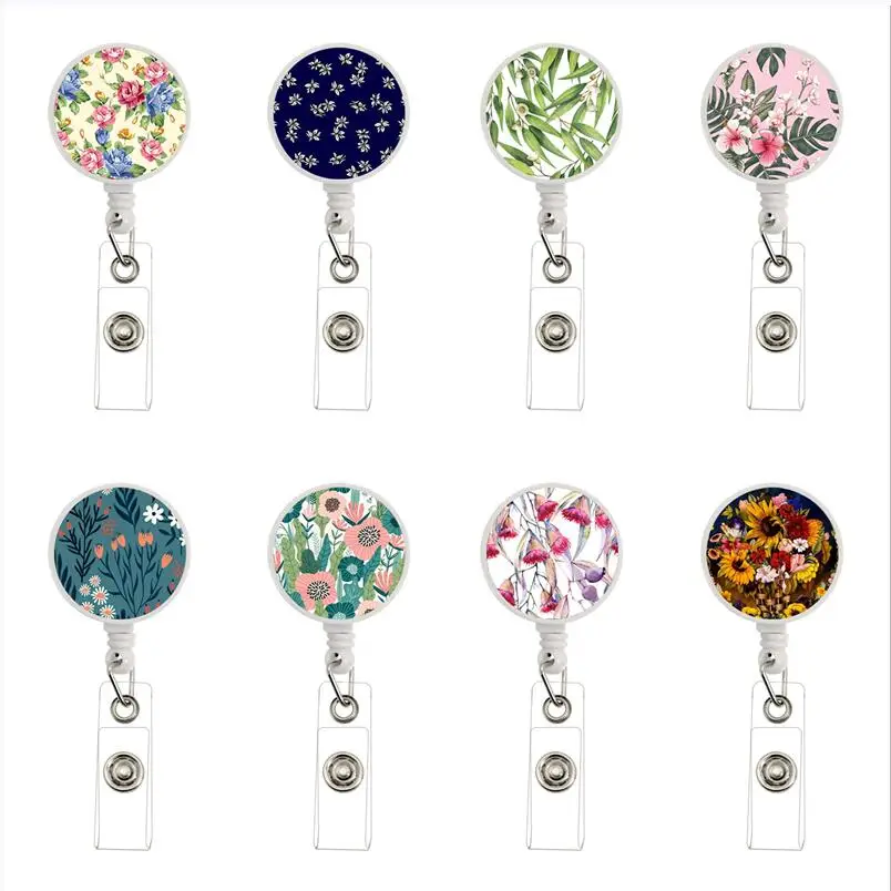 25 colores de moda flor retráctil enfermera insignia carrete Clip titular de la insignia carrete de cable insignia de retroceso estudiantes Doctor titular de la tarjeta de identificación