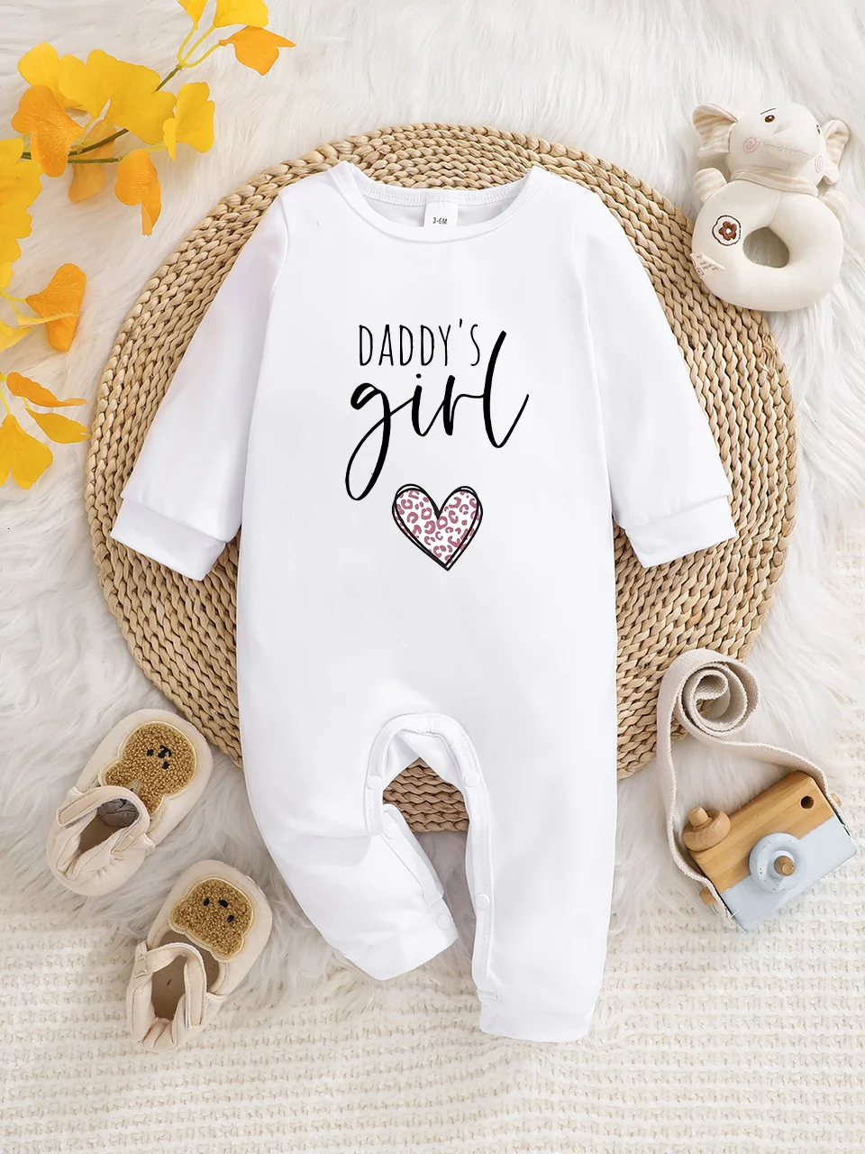 A baby long-sleeved onesie with interesting letter prints. It features a buttoned design for easy putting on and taking off